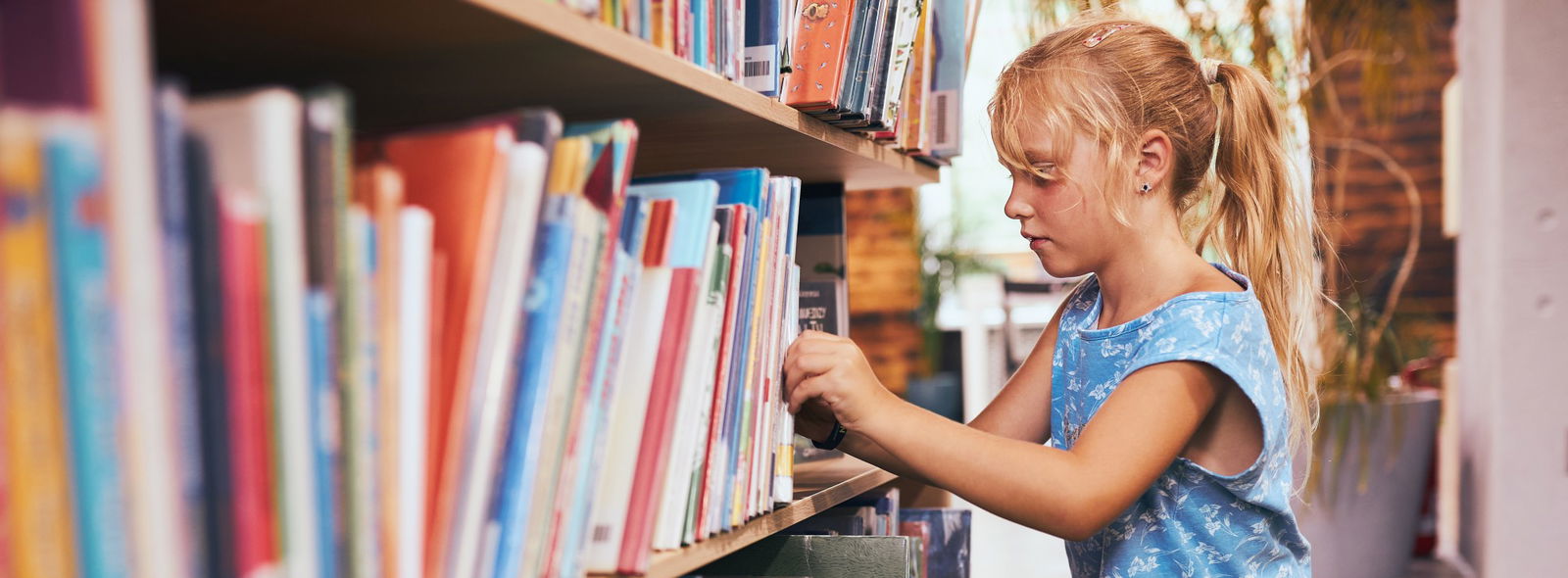 Young girl exploring the library.